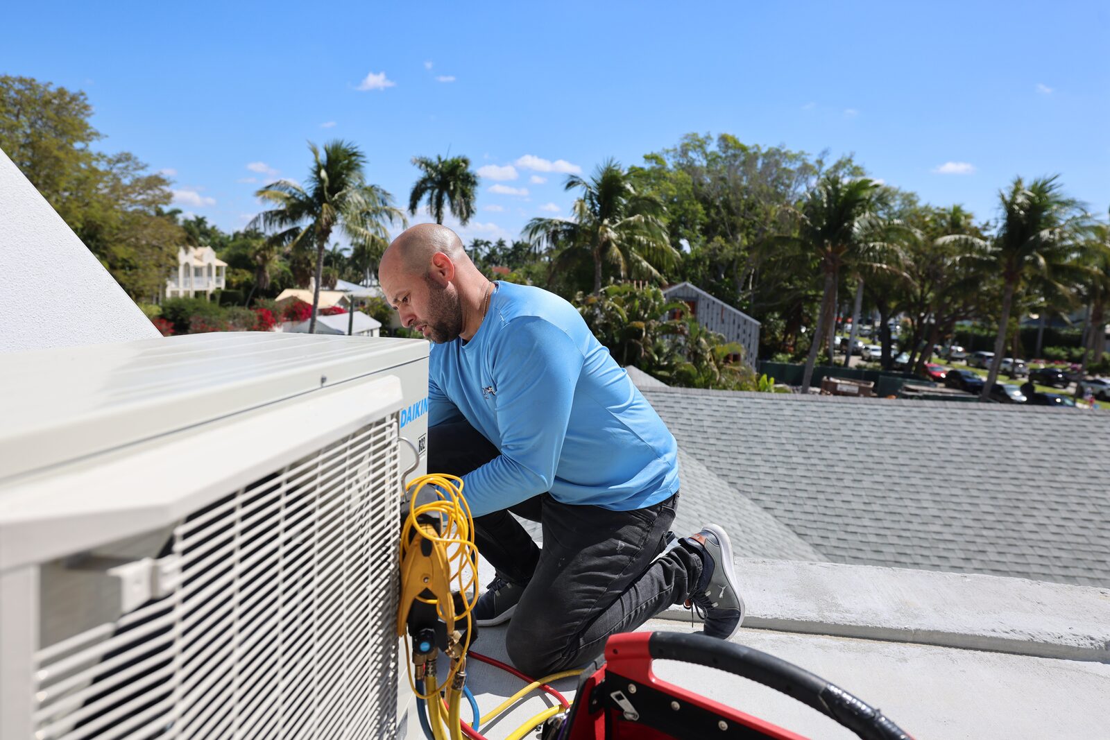 Final checks on a rooftop condenser under a SWFL sky
